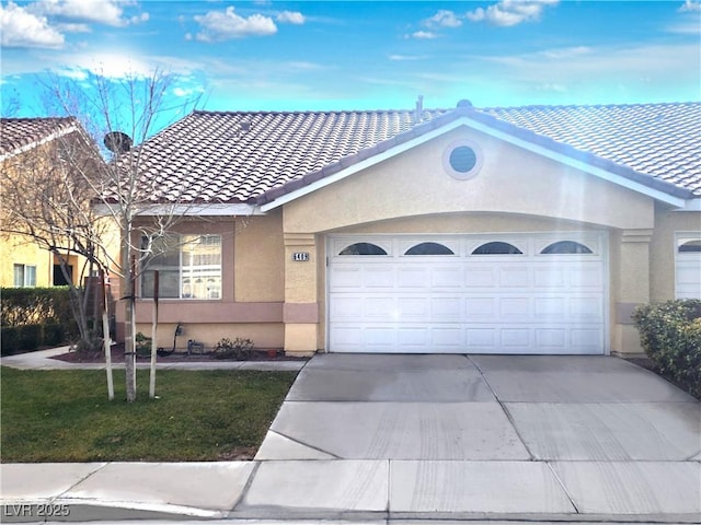 ranch-style house featuring a tiled roof, concrete driveway, an attached garage, and stucco siding