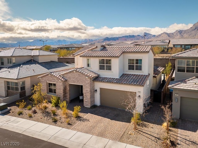 view of front of house featuring a residential view, a mountain view, and decorative driveway