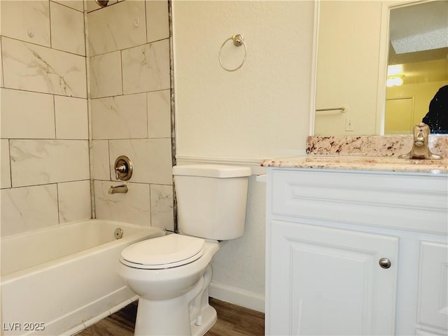 full bath with toilet, shower / bath combination, wood finished floors, and vanity