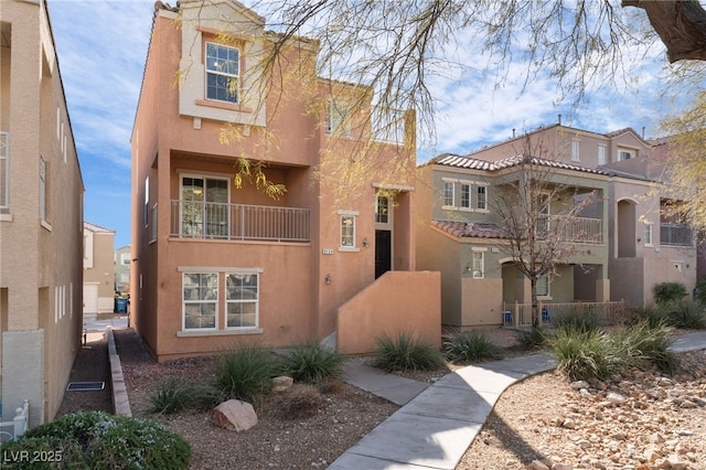 view of front of home featuring a tiled roof and stucco siding