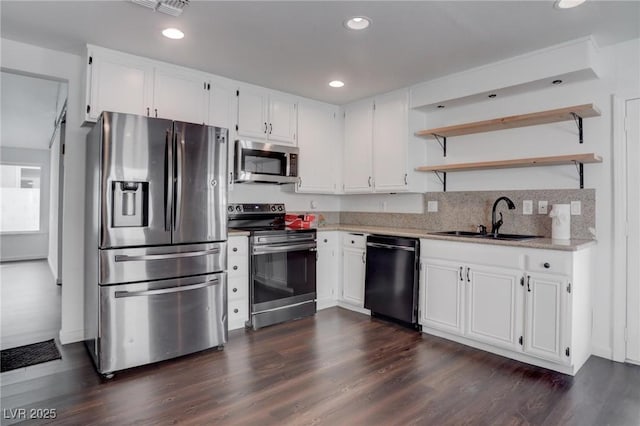 kitchen featuring appliances with stainless steel finishes, white cabinets, a sink, and light countertops