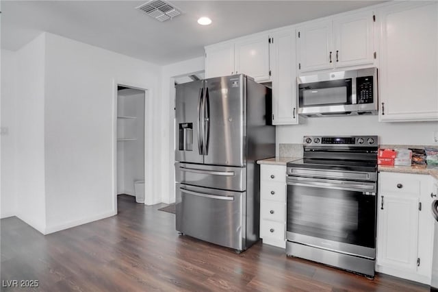 kitchen featuring appliances with stainless steel finishes, light countertops, visible vents, and white cabinetry