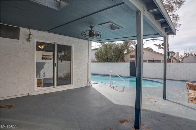 view of swimming pool with ceiling fan, a fenced in pool, a fenced backyard, and a patio