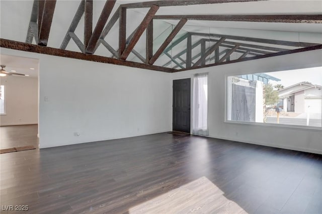 spare room featuring high vaulted ceiling, beamed ceiling, dark wood finished floors, and a ceiling fan