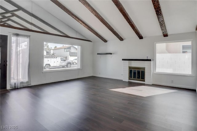 unfurnished living room featuring vaulted ceiling with beams, dark wood-style flooring, a brick fireplace, and baseboards