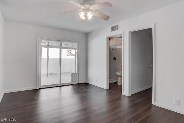 empty room with a ceiling fan, dark wood-style flooring, visible vents, and baseboards