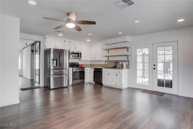 kitchen featuring appliances with stainless steel finishes, white cabinets, visible vents, and open shelves