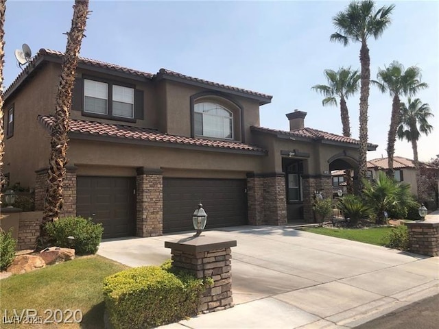 mediterranean / spanish-style home featuring an attached garage, driveway, a tile roof, and stucco siding