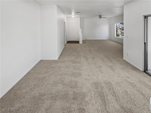 empty room with a ceiling fan, light carpet, and visible vents