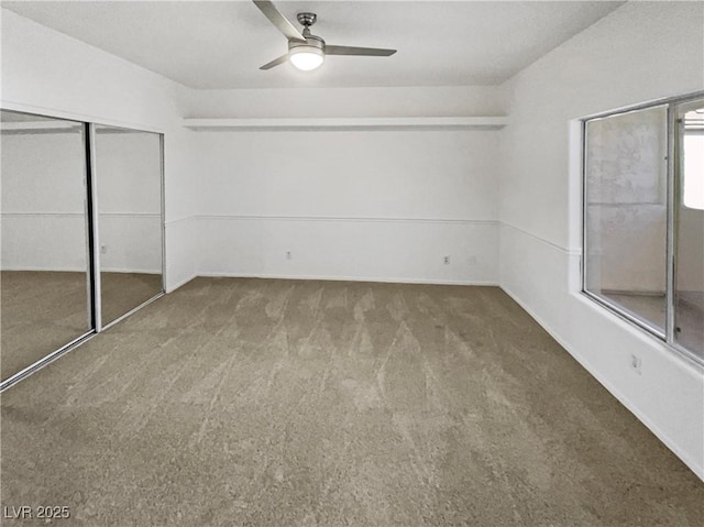 unfurnished bedroom with a ceiling fan, carpet, and a closet