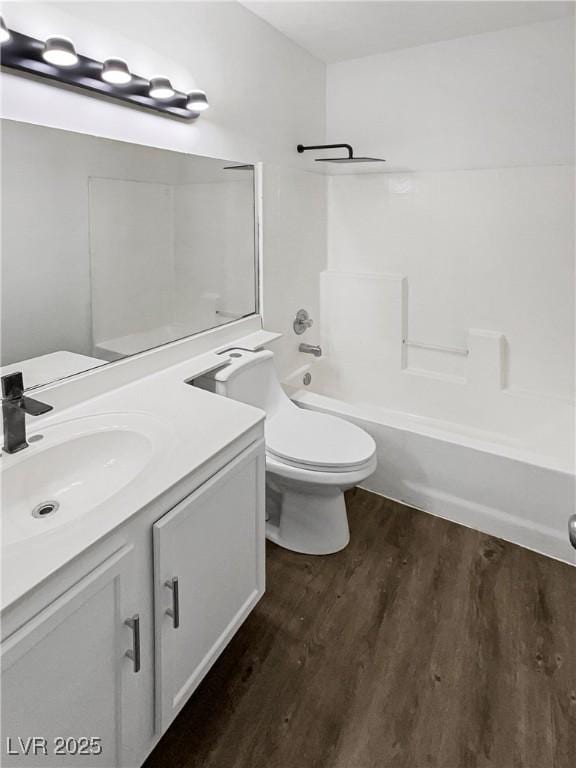 full bathroom featuring shower / bathing tub combination, vanity, toilet, and wood finished floors