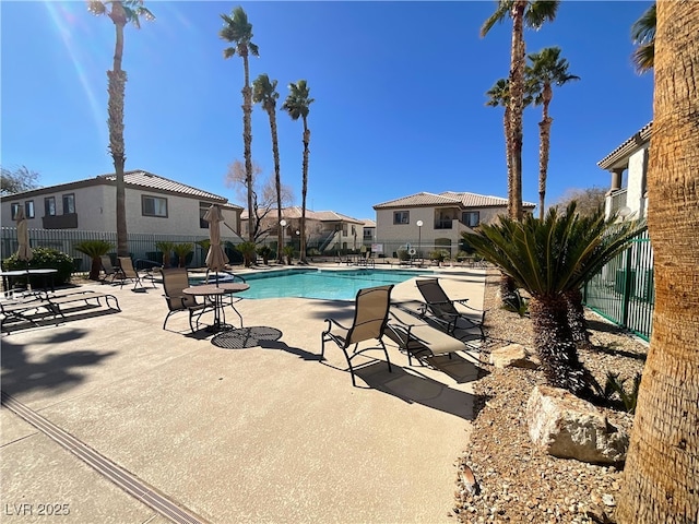 pool featuring a residential view, fence, and a patio