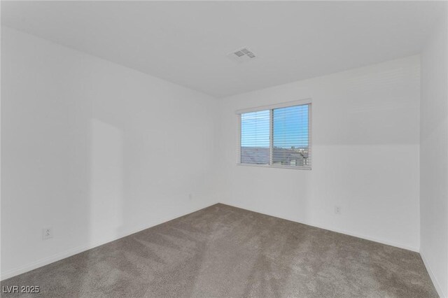 unfurnished room featuring visible vents and carpet flooring