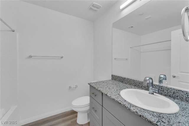 full bath featuring toilet, wood finished floors, visible vents, vanity, and baseboards