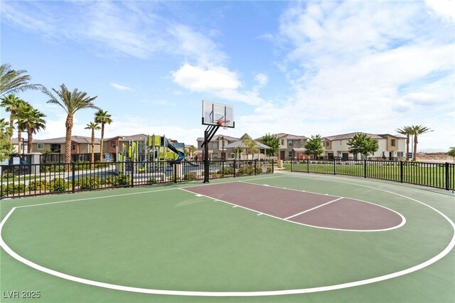 view of sport court featuring community basketball court, fence, and a residential view