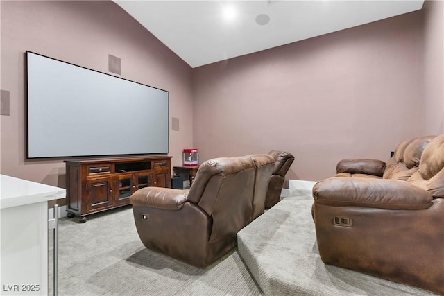 home theater with lofted ceiling and light colored carpet