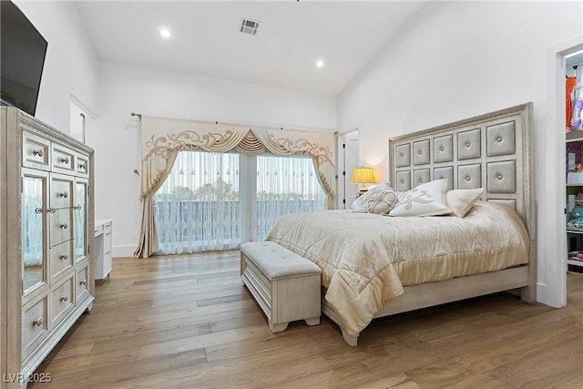 bedroom with high vaulted ceiling, recessed lighting, visible vents, access to outside, and light wood-type flooring