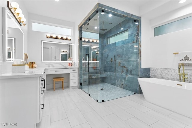 full bath with a shower stall, a freestanding bath, and vanity