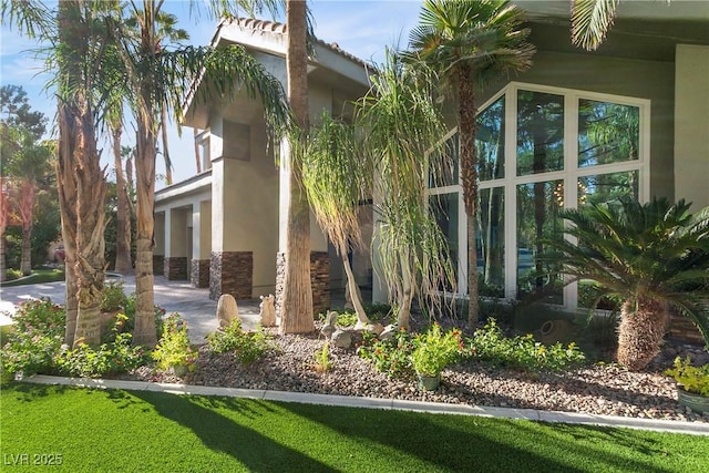 view of property exterior with a yard and stucco siding