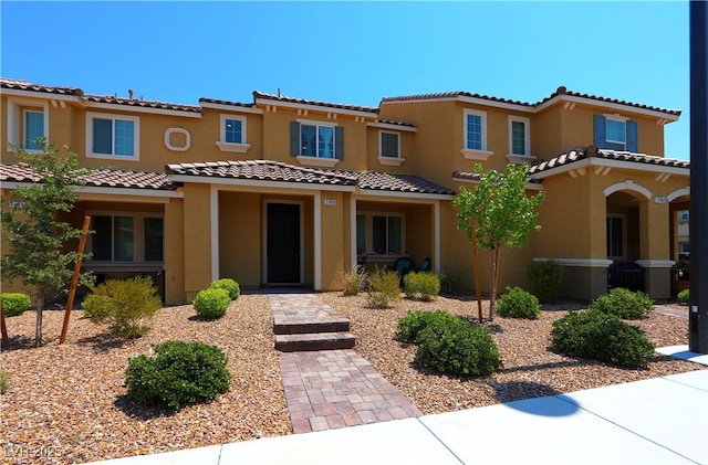 mediterranean / spanish-style home with stucco siding