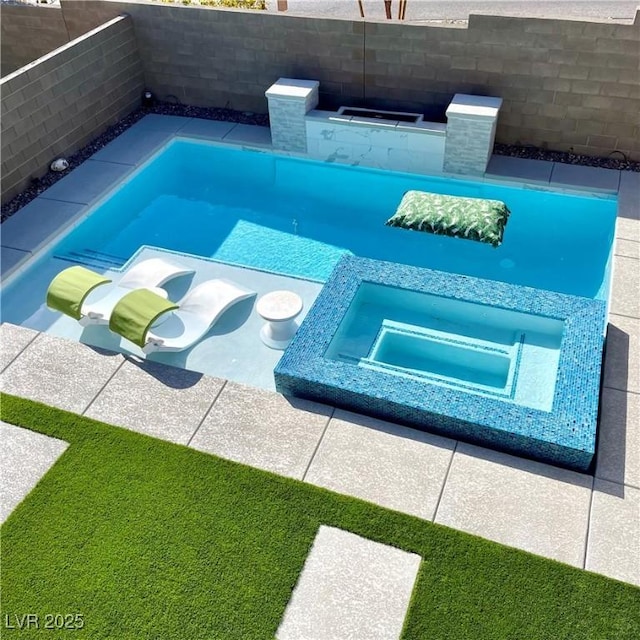 view of pool featuring an in ground hot tub and a fenced backyard