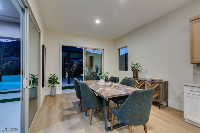 dining room with light wood-type flooring, baseboards, and recessed lighting