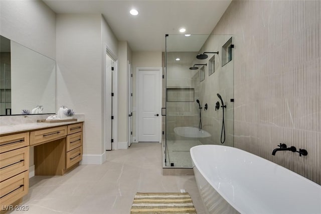 bathroom with tile patterned flooring, recessed lighting, vanity, a soaking tub, and a shower stall