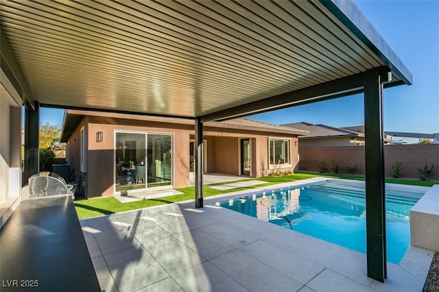 view of swimming pool with a patio area, fence, and a fenced in pool