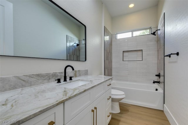 bathroom with toilet, bathtub / shower combination, wood finished floors, and vanity