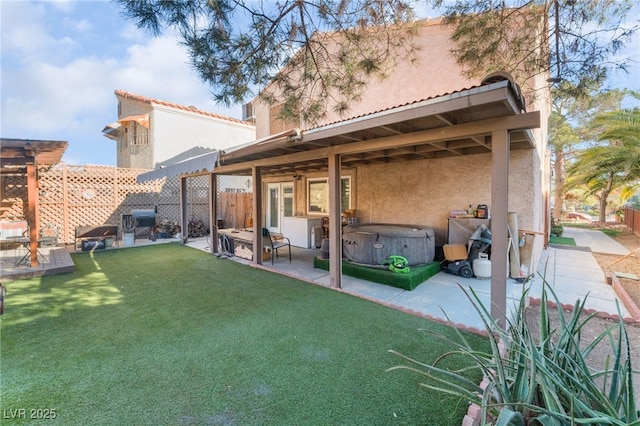 2245 Saint Paul Way, Las Vegas, NV 89104 - rear view of property with a yard, a patio, stucco siding, a fenced backyard, and a jacuzzi
