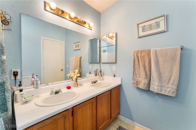 2245 Saint Paul Way, Las Vegas, NV 89104 - full bathroom featuring double vanity, baseboards, and a sink