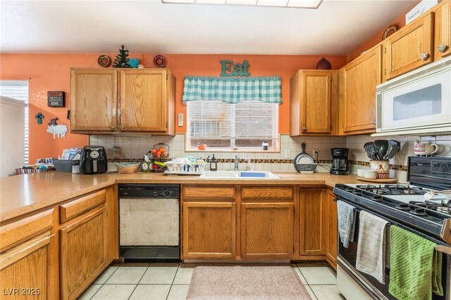 2245 Saint Paul Way, Las Vegas, NV 89104 - kitchen featuring light tile patterned floors, white appliances, a sink, light countertops, and decorative backsplash