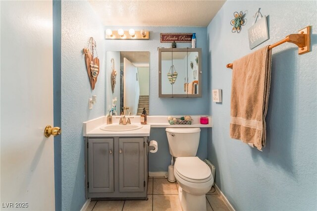 2245 Saint Paul Way, Las Vegas, NV 89104 - half bathroom featuring toilet, vanity, baseboards, and tile patterned floors