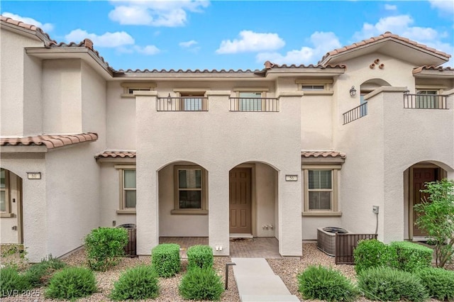 view of front of home with a tiled roof and stucco siding