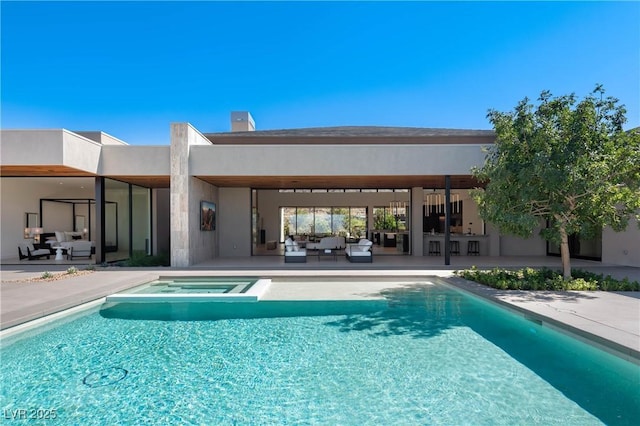 view of swimming pool featuring a pool with connected hot tub, an outdoor hangout area, and a patio area