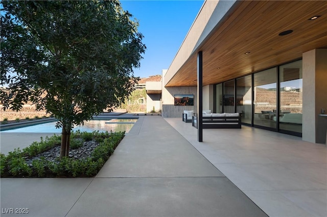 view of patio / terrace with an outdoor living space and an outdoor pool