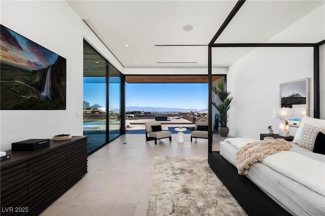 living area featuring a wall of windows and tile patterned floors