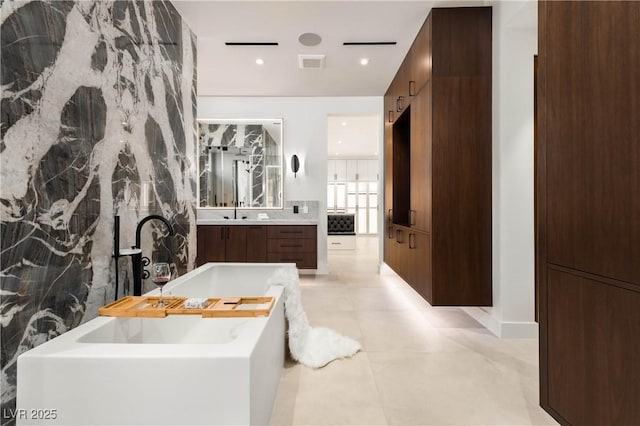 bathroom with a garden tub, recessed lighting, visible vents, vanity, and tile patterned flooring