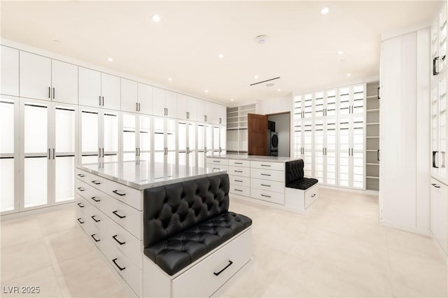 spacious closet with light tile patterned floors and washer / clothes dryer