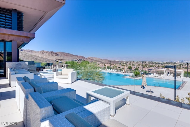 view of pool with a mountain view, an outdoor living space, and a patio