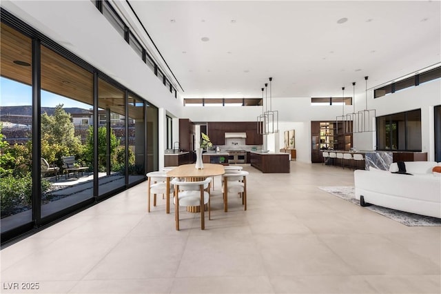 dining room with a towering ceiling