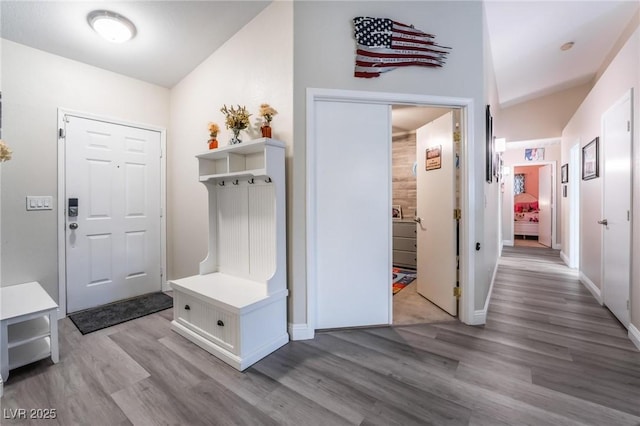 mudroom featuring wood finished floors and baseboards