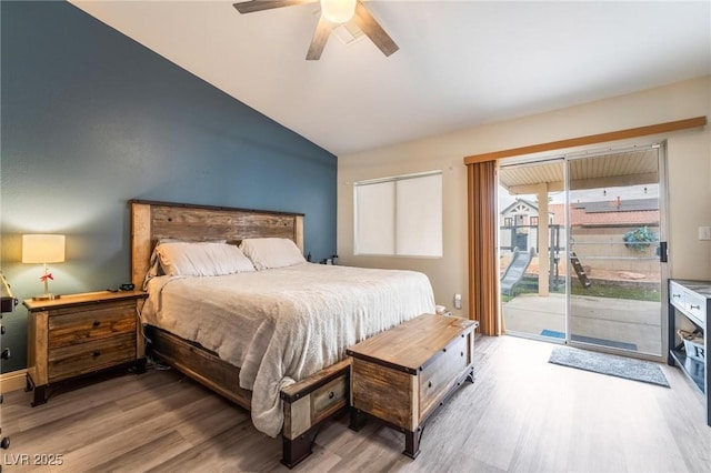 bedroom featuring light wood-type flooring, lofted ceiling, a ceiling fan, and access to outside