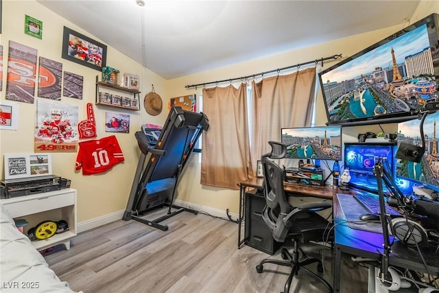 interior space with wood finished floors and baseboards