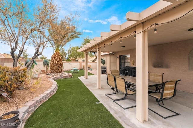 view of yard with outdoor dining space, a patio, and fence