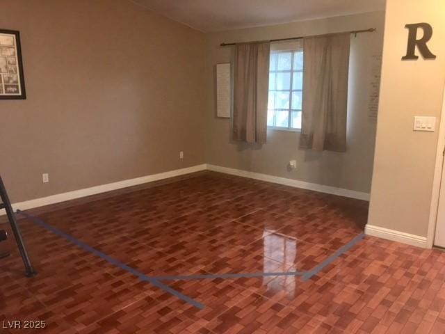 empty room with wood finished floors and baseboards