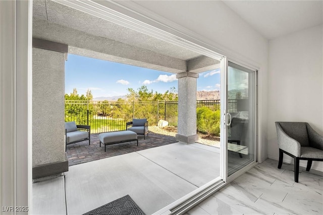 interior space with marble finish floor and a wealth of natural light