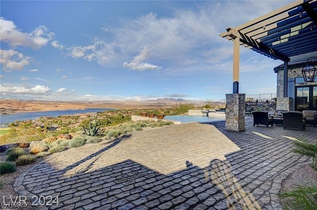 view of patio with outdoor lounge area, a water view, and a pergola