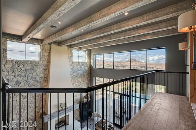 hall featuring visible vents, a mountain view, and beamed ceiling