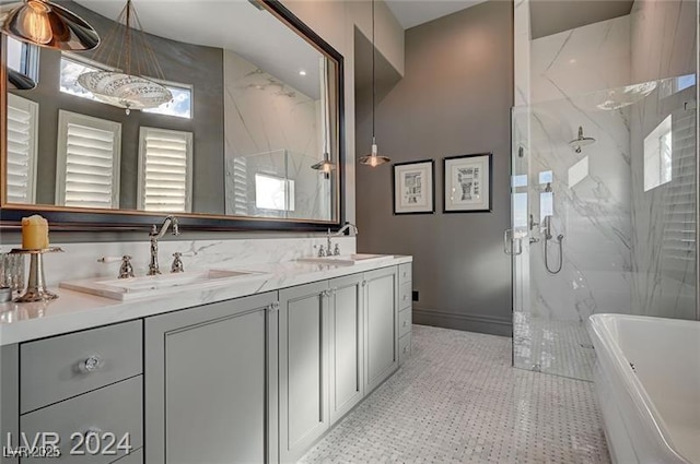 full bathroom with a freestanding bath, double vanity, a sink, and a marble finish shower